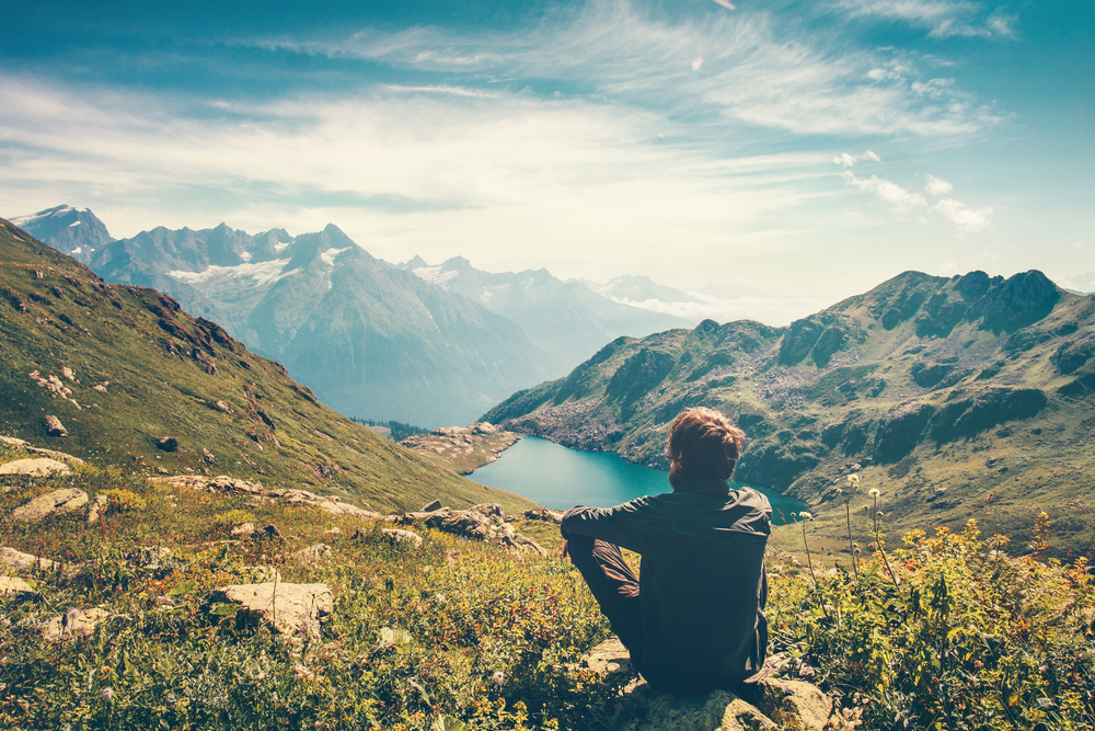 Person meditating outdoors with a calm expression, representing mental clarity and physical well-being