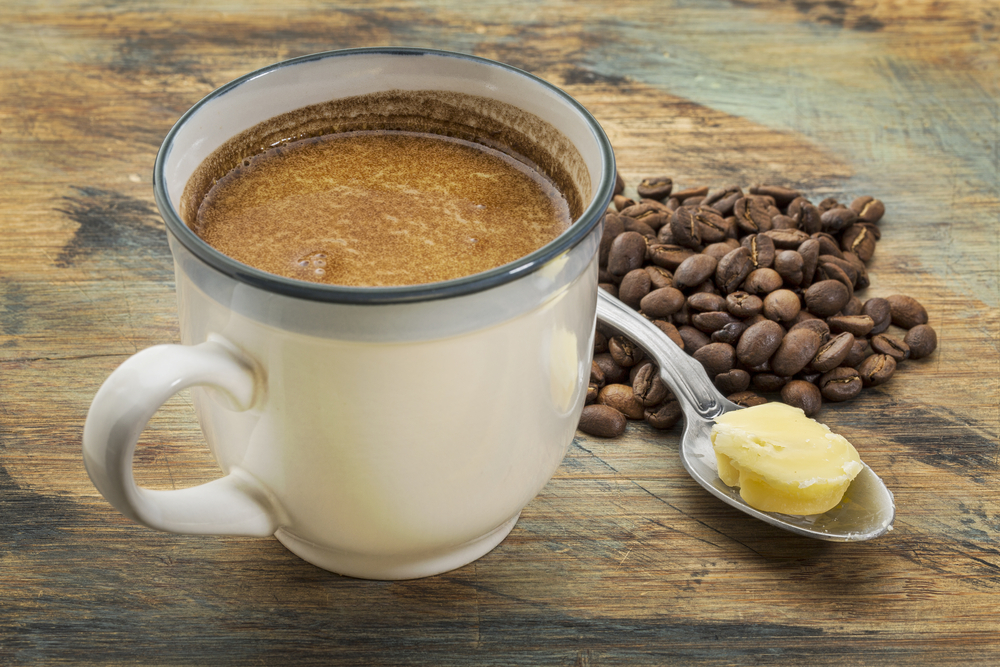 Cup of butter coffee on a table representing energy, focus, and healthy fats